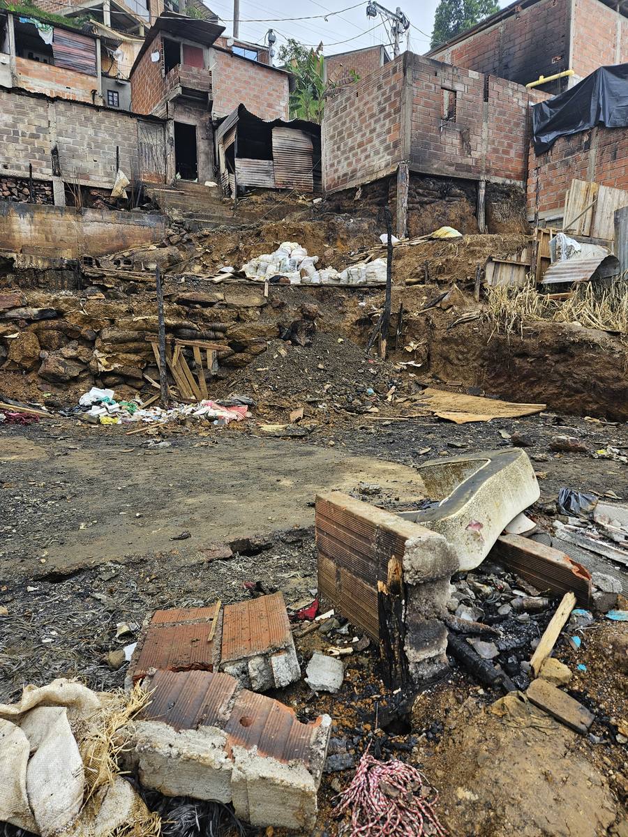 Burned remains of homes on a hillside in Medellín
