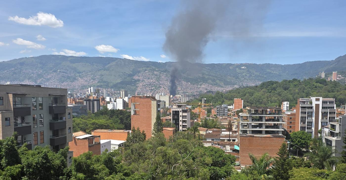 Smoke rising from the hillside neighborhoods of Medellín